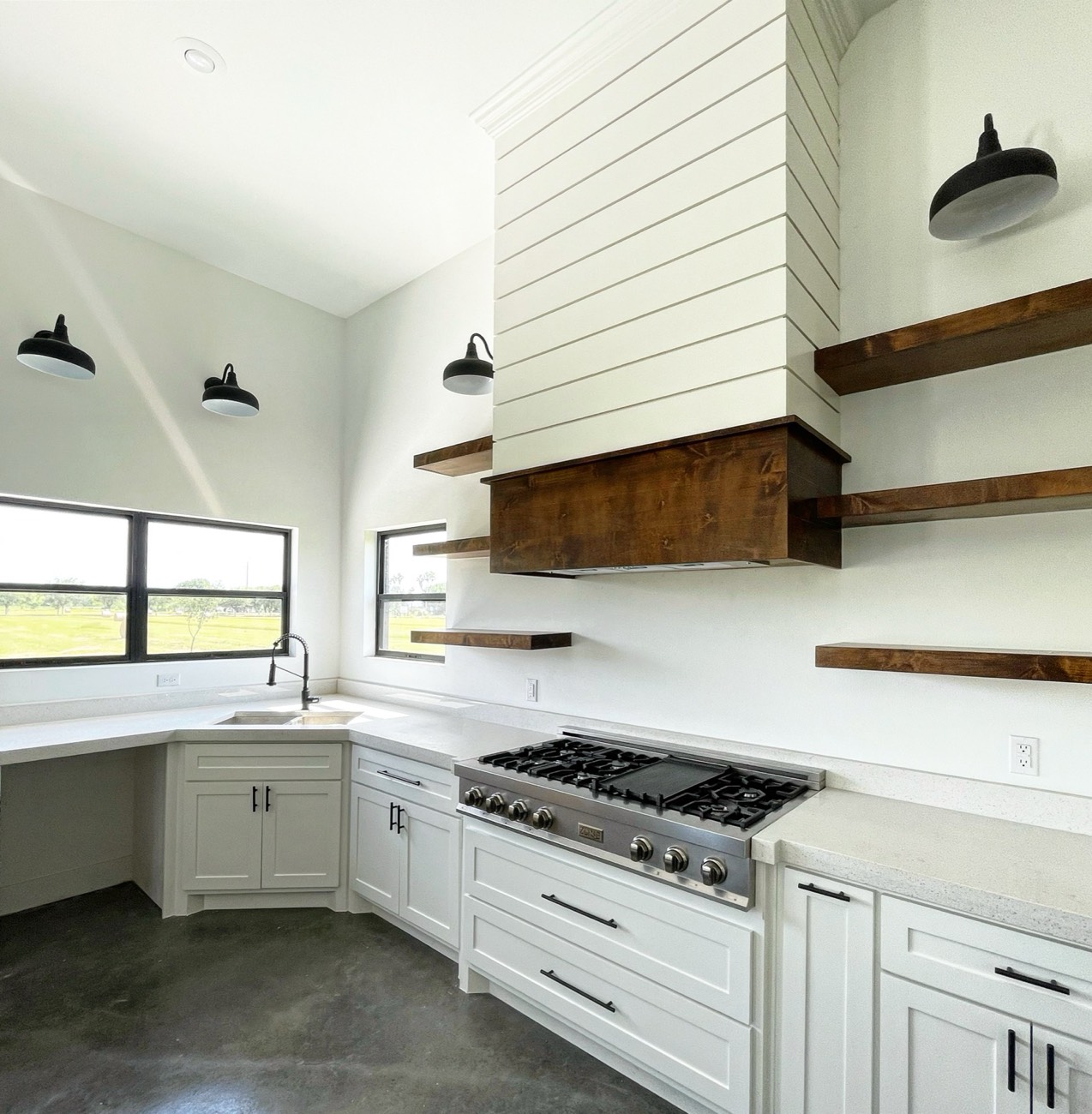 Custom kitchen with shiplap range hood and floating wood shelves