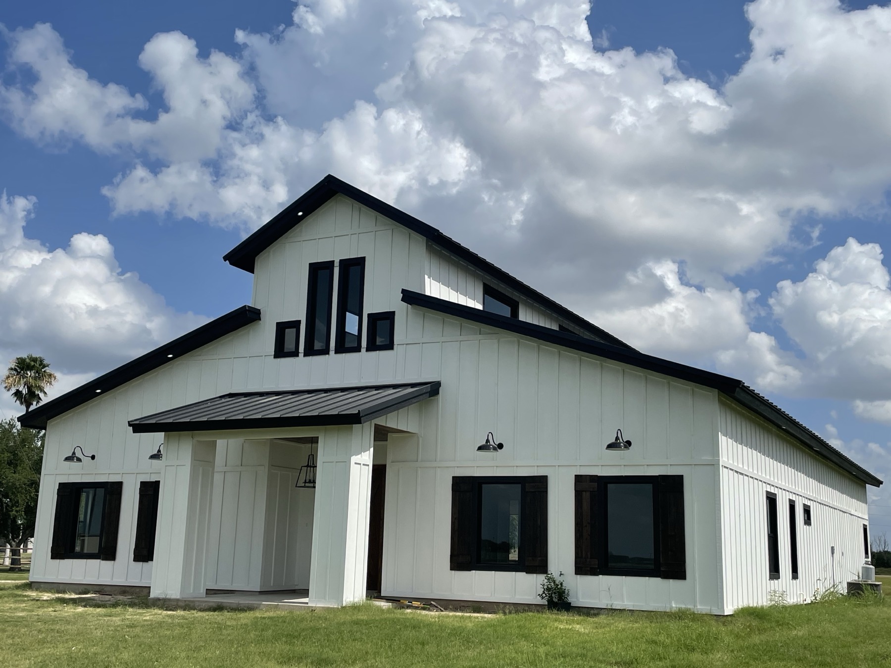 White modern farmhouse built by Blue Rock & Co. under a dramatic Texas sky